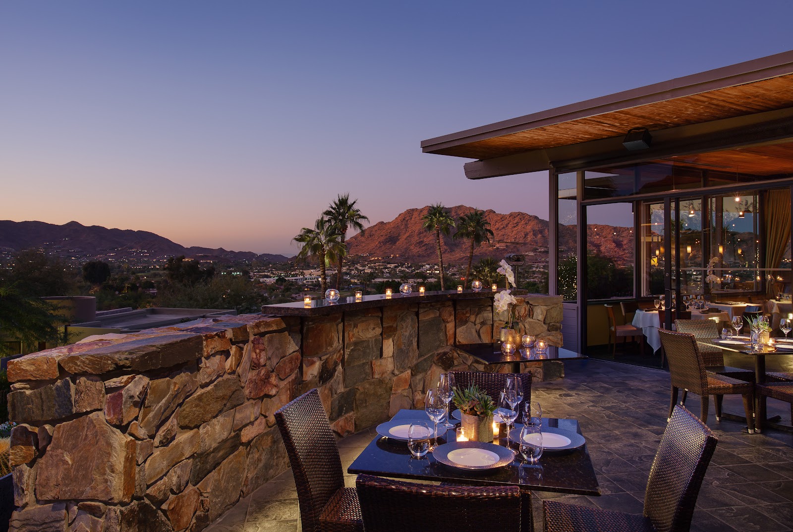 Camelback Mountain glowing at sunset behind a Scottsdale resort dining terrace