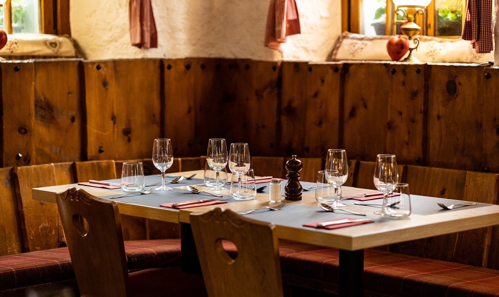 A single fondue setting in a wood-panelled Zermatt stube with the Matterhorn beyond