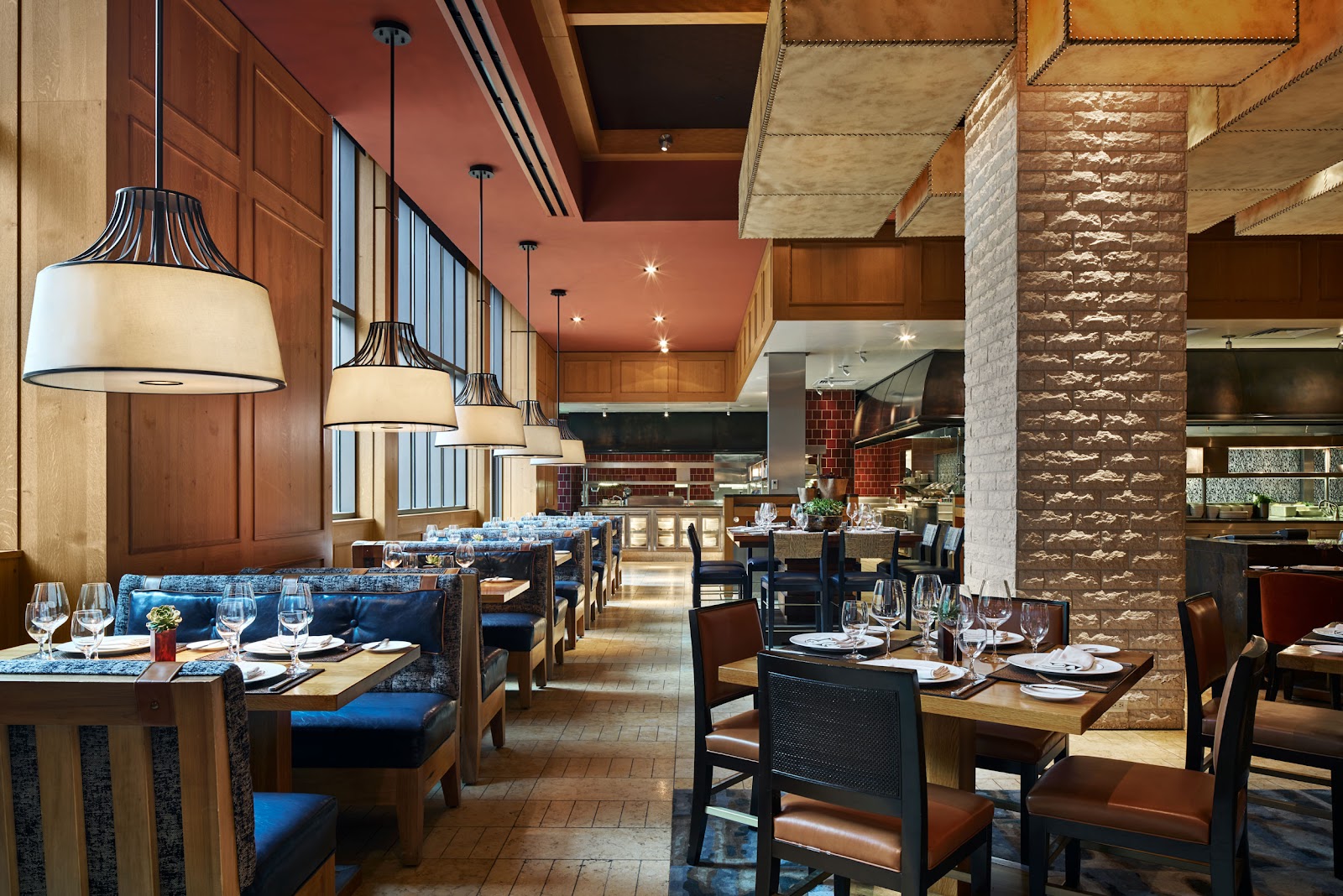 A neon-lit bar and open kitchen serving food late at night in Dallas