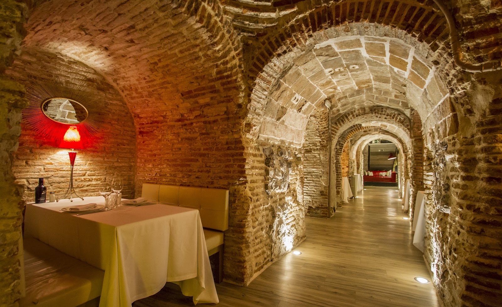 A long table set for a group dinner in a historic Madrid restaurant