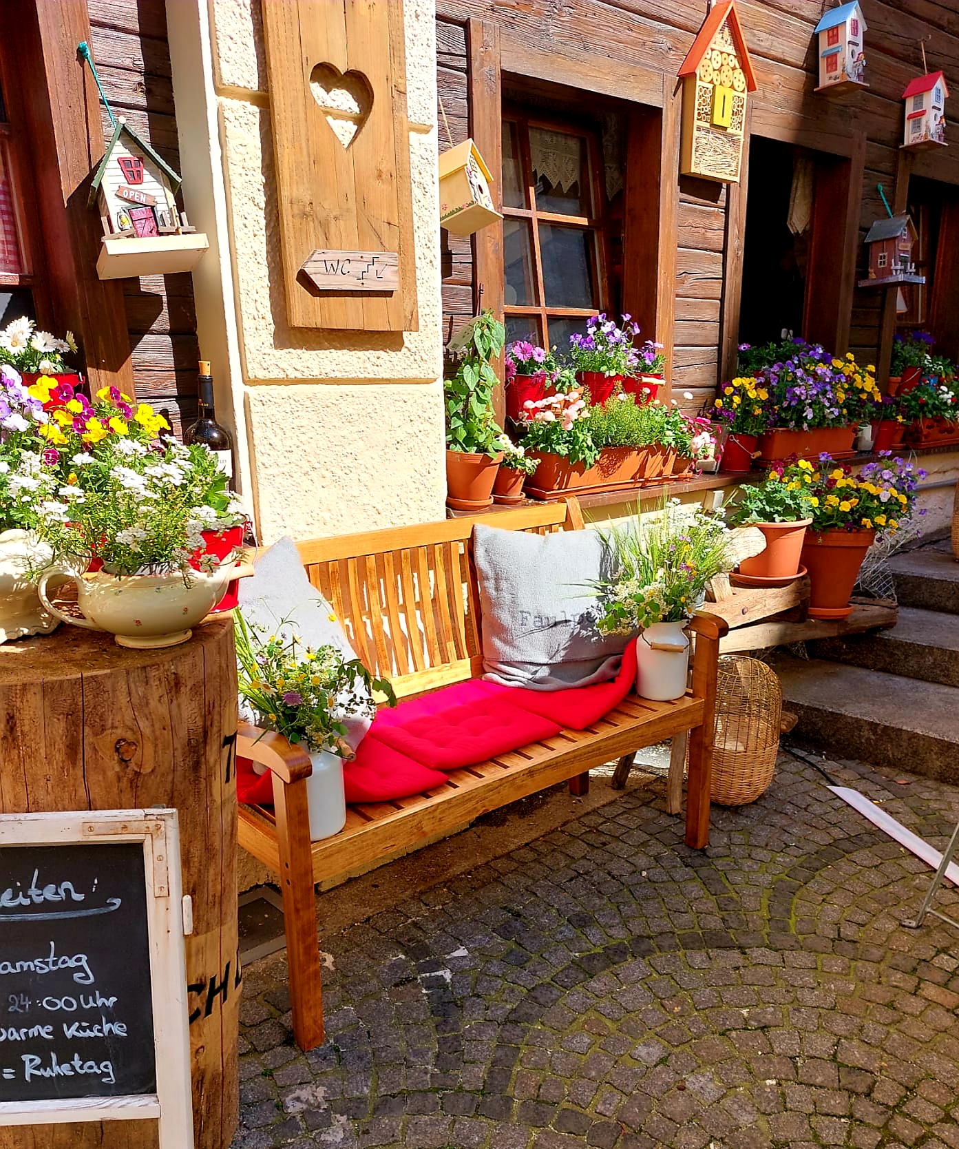 A shared wooden bench filling up at a Munich beer hall, Altstadt