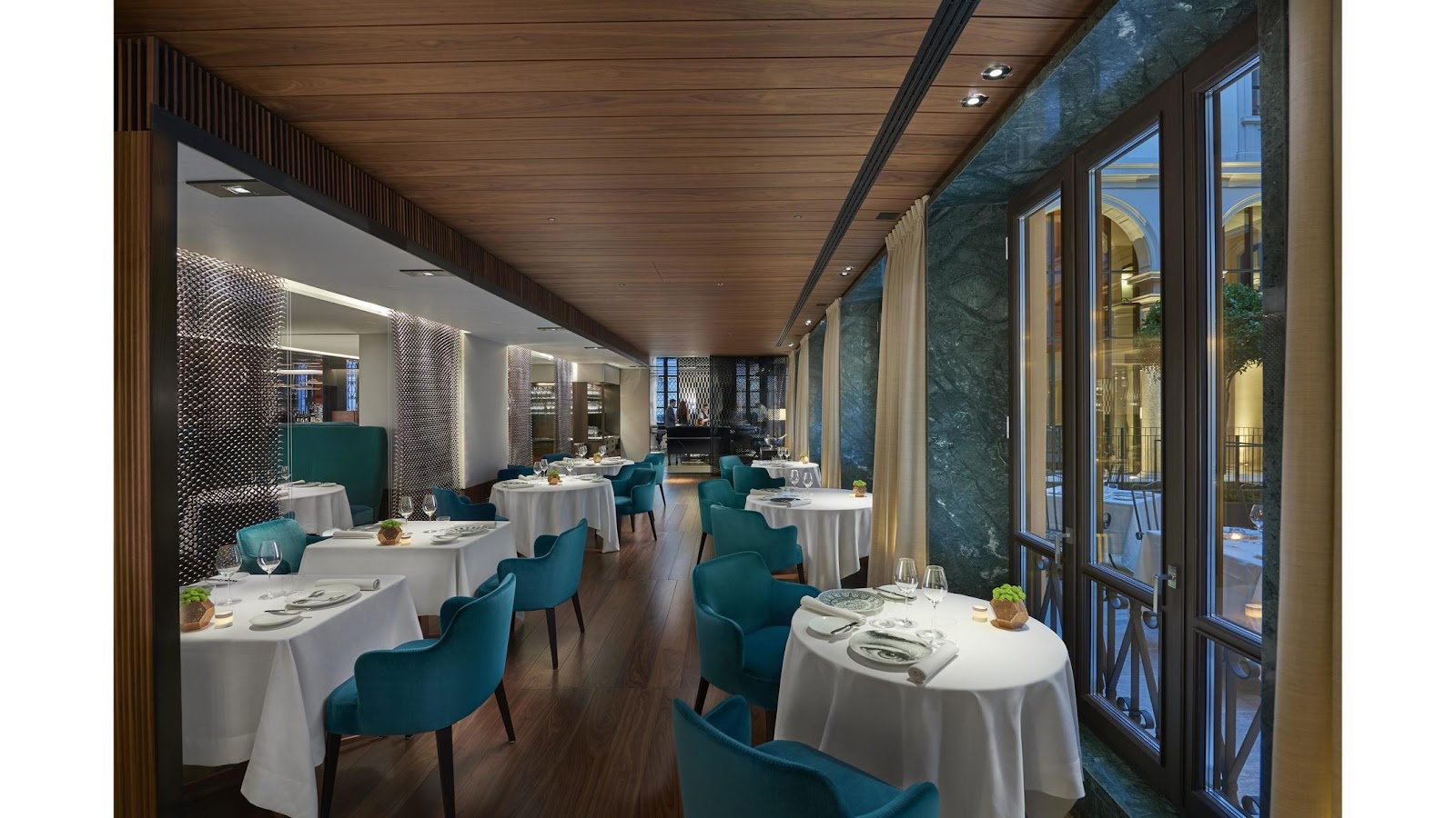 A private dining room set for a formal dinner in Milan