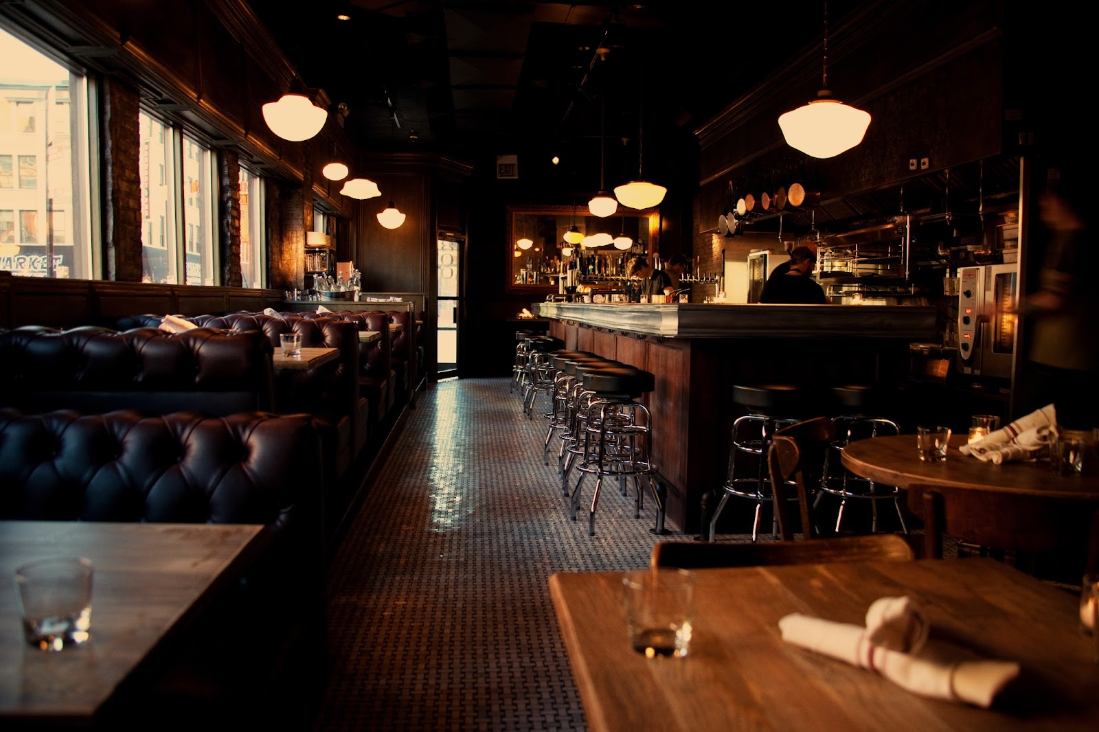 A neon-lit bar and open kitchen serving food late at night in Chicago