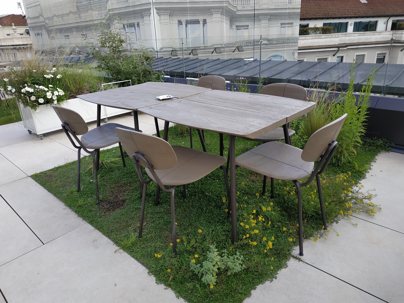 A rooftop terrace with the Duomo spires beyond, Milan