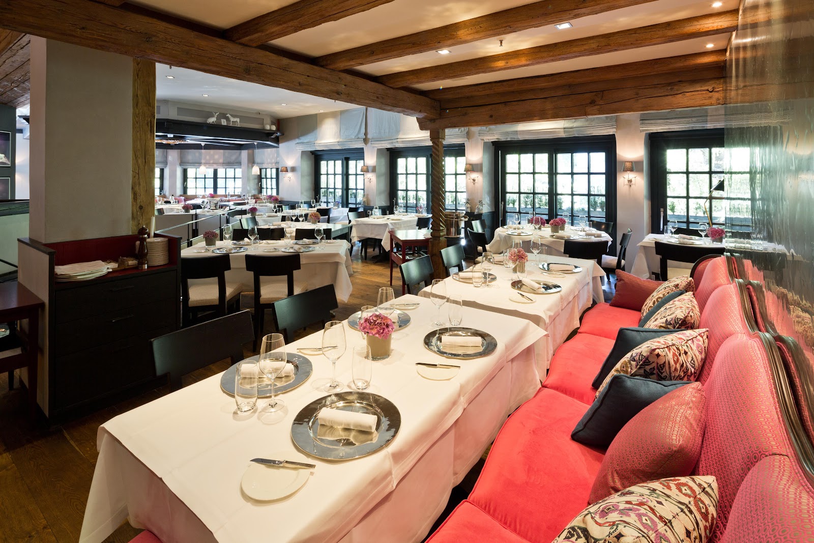 A panelled private dining salon set for dinner in Munich