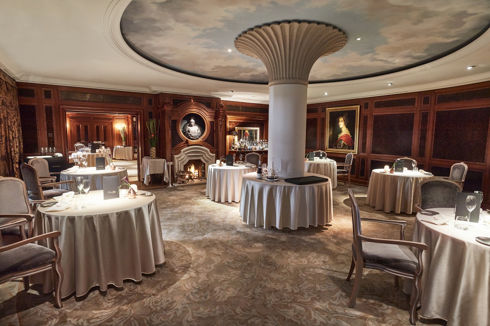 A formal, well-spaced dining room set for a business dinner in Berlin