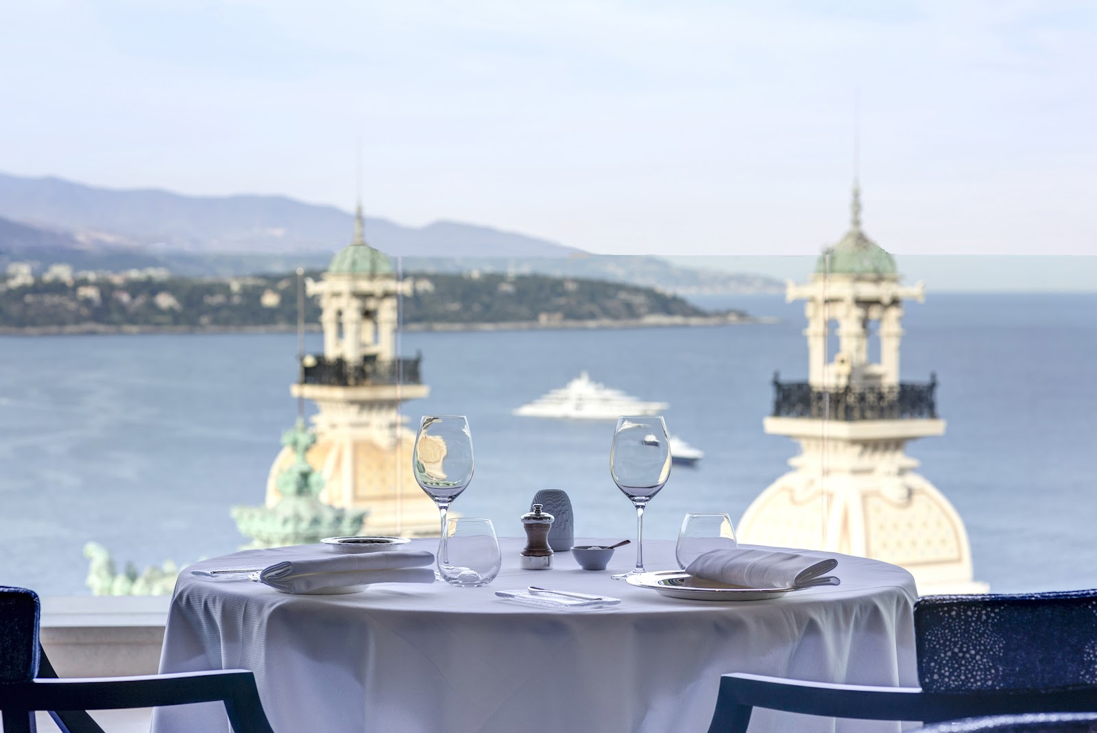 A rooftop terrace above the sea and the Monte Carlo casino at dusk