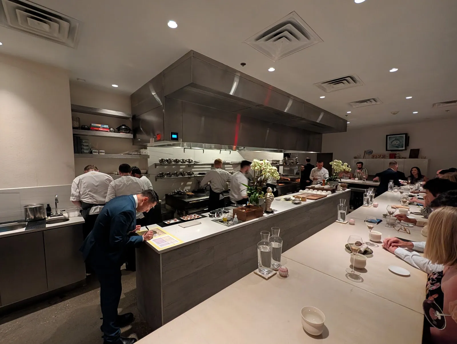 A chef plating a course at a tasting counter in Washington DC