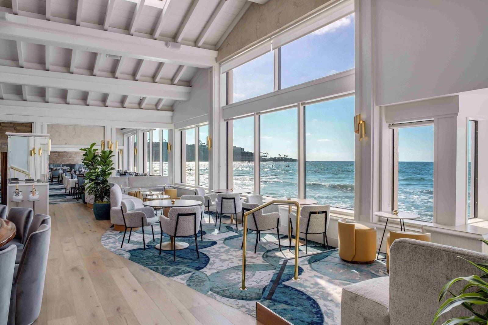 A single seat at a raw oyster bar overlooking La Jolla Cove, set for a solo diner