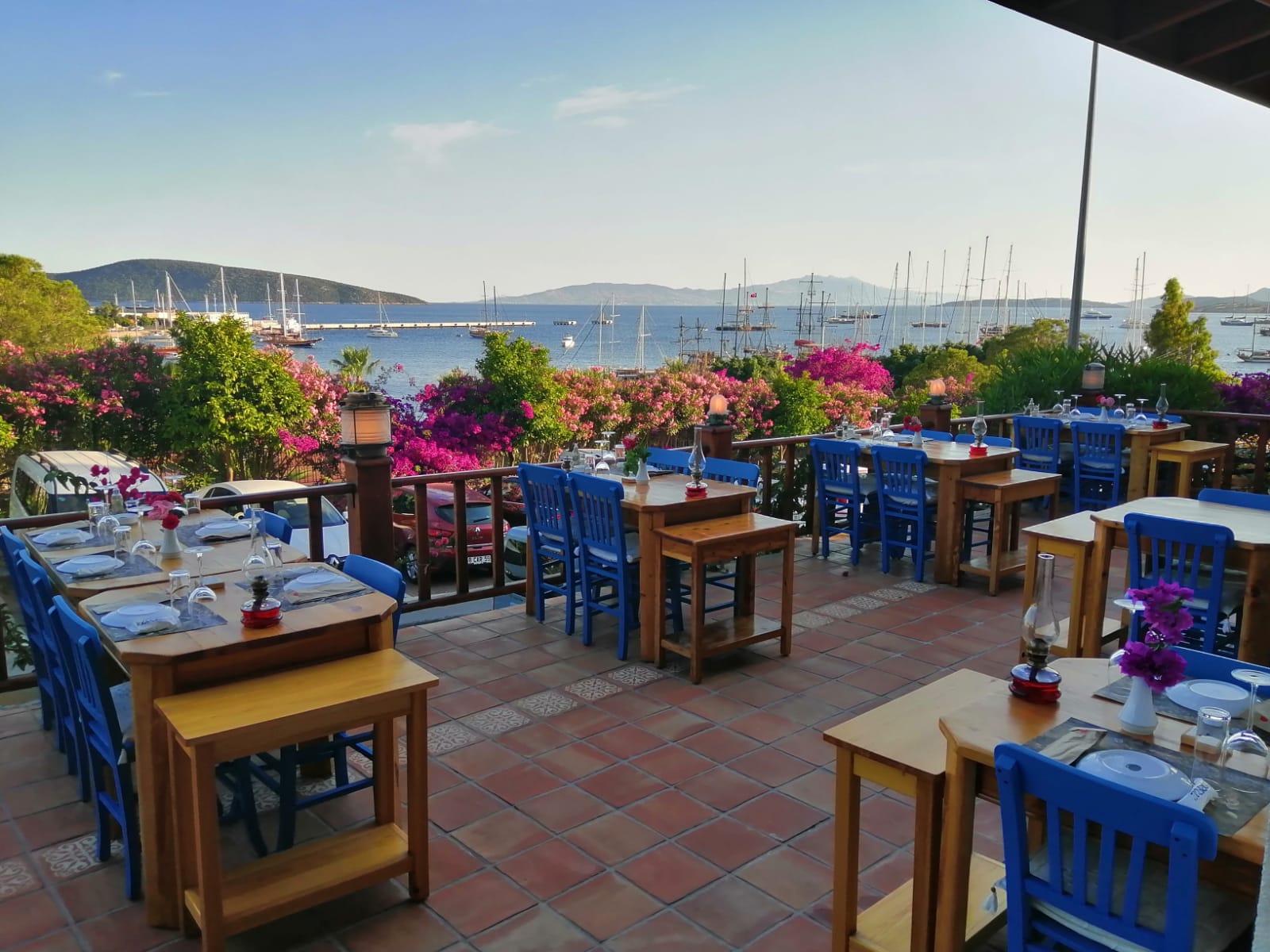 A candlelit waterfront dinner table on the Bodrum bay at dusk