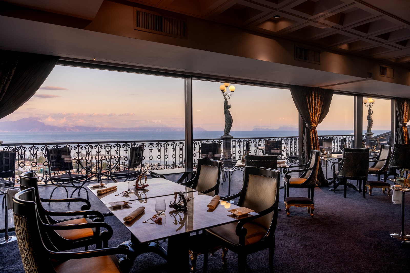 A terrace table set for a birthday celebration over the Bay of Naples