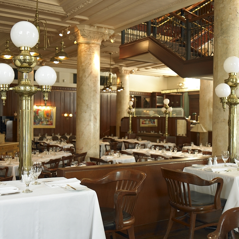 A long restaurant table set for a team dinner in a Boston dining room