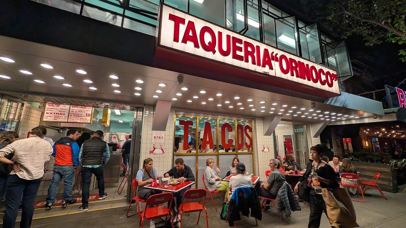 A late-night taqueria counter still serving in Roma, Mexico City