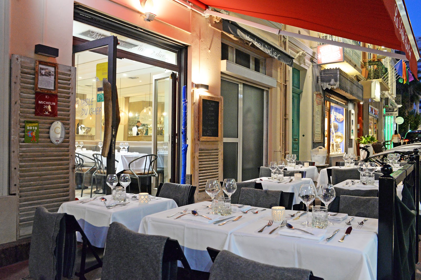 An open-kitchen counter seat set for one diner in Cannes
