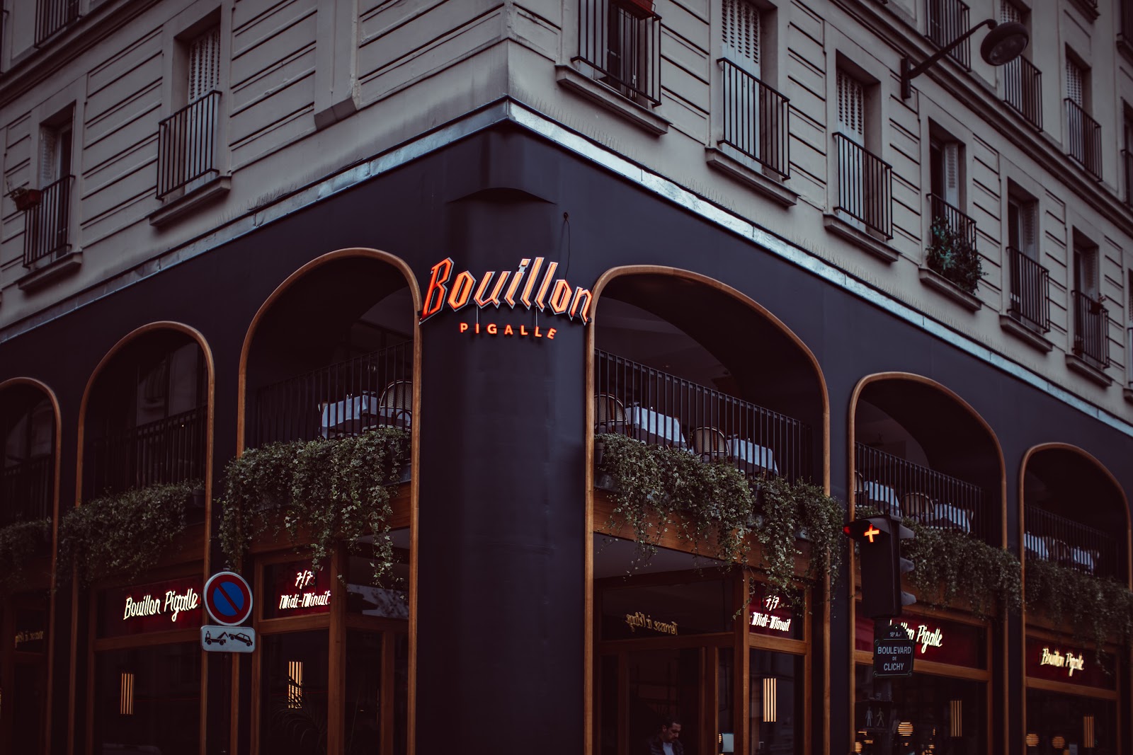 A family table in a Paris brasserie with steak-frites and a carafe of water