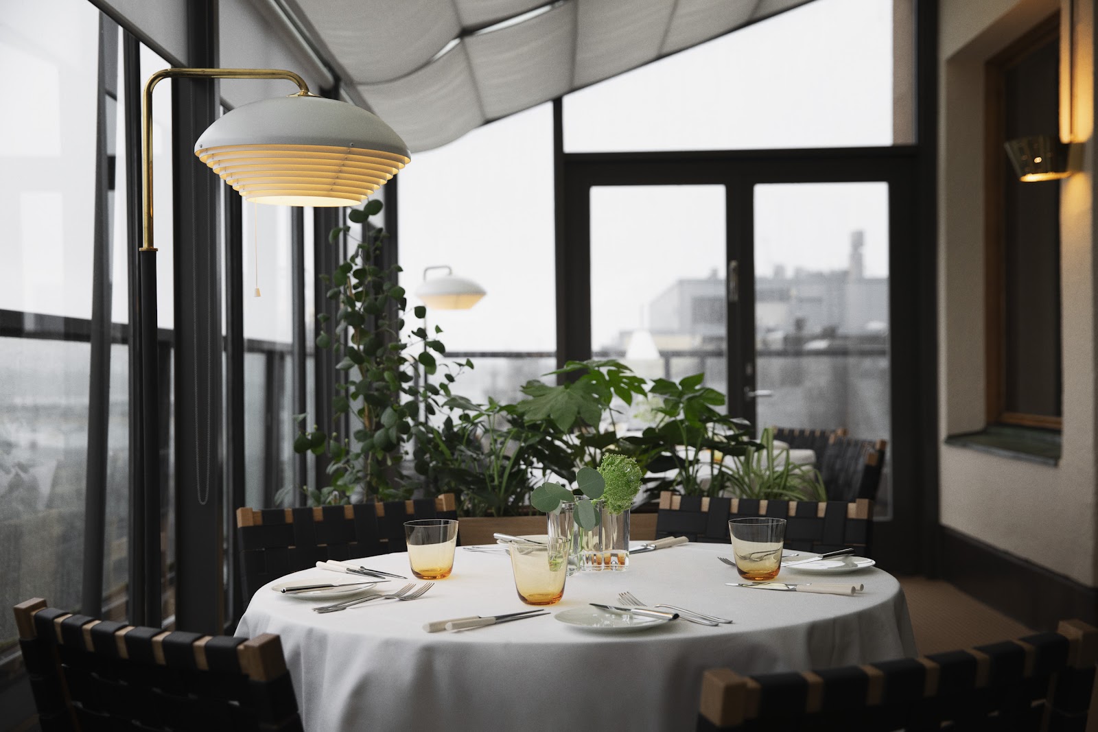 A candle-lit table set for an anniversary dinner in an elegant Helsinki dining room