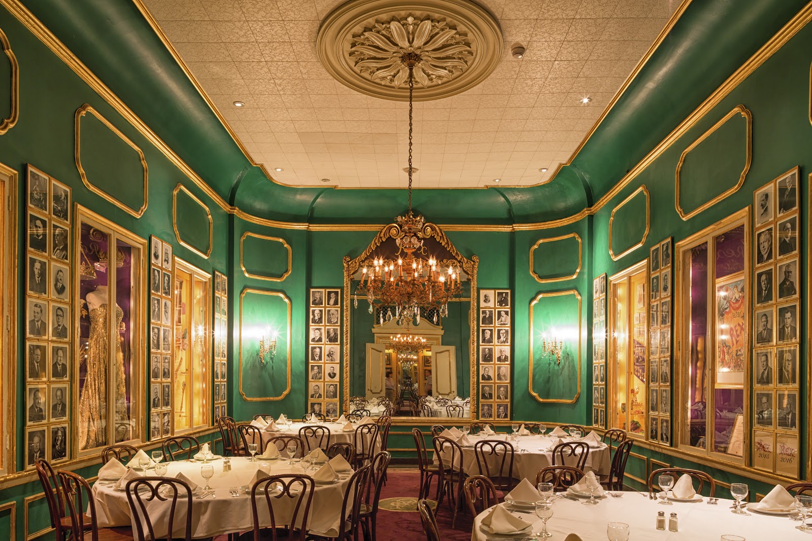 A New Orleans restaurant private dining room set for a large team dinner with chandeliers