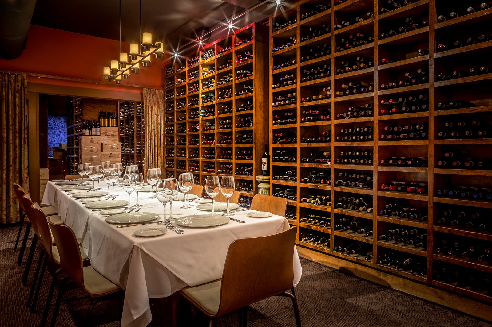 A restaurant wine cellar behind glass in a Denver dining room