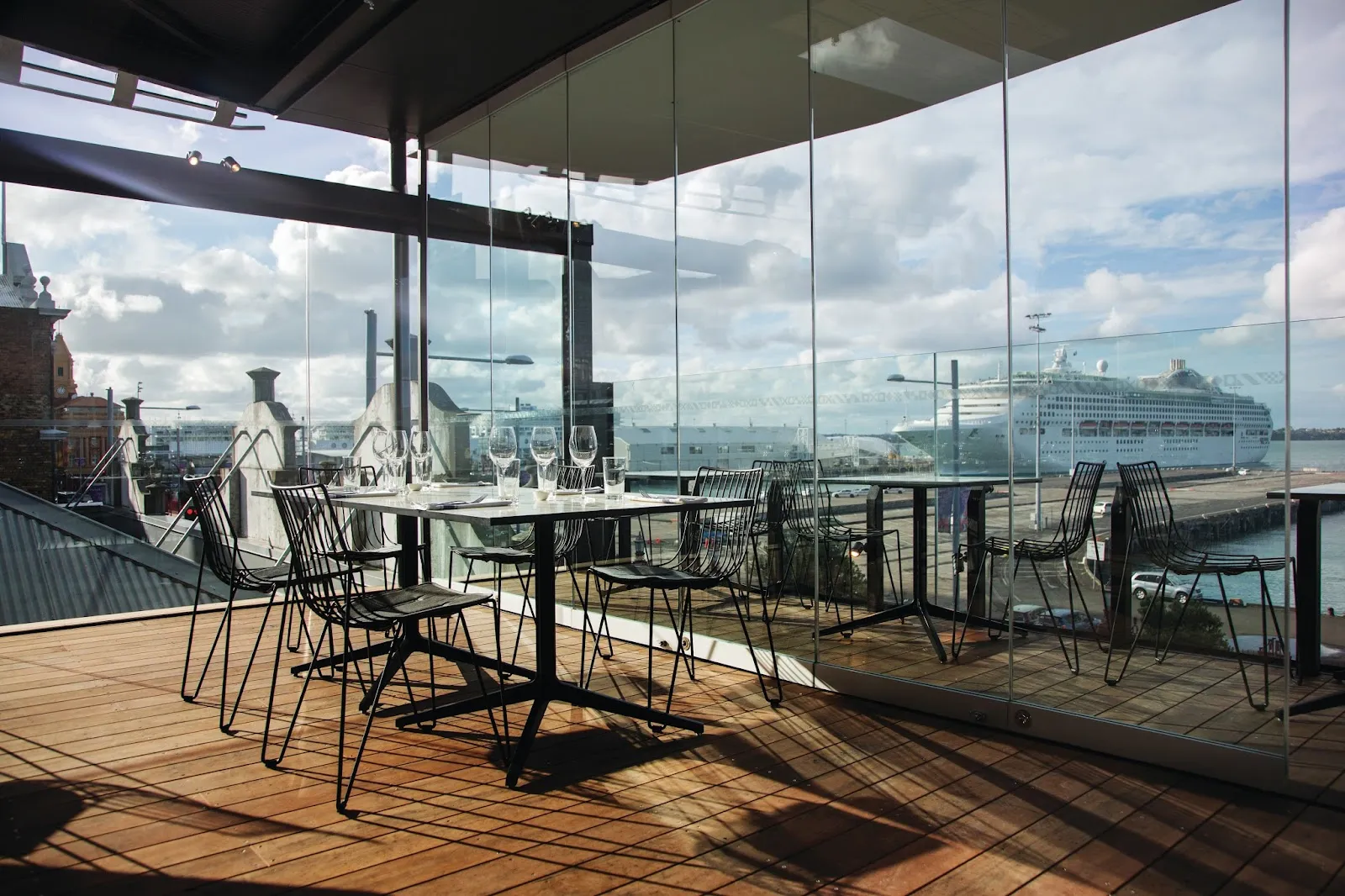 A waterfront table set for two at dusk in Auckland