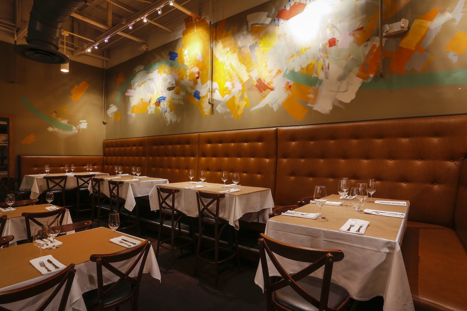 A couple sharing small plates and wine at an intimate Orlando restaurant