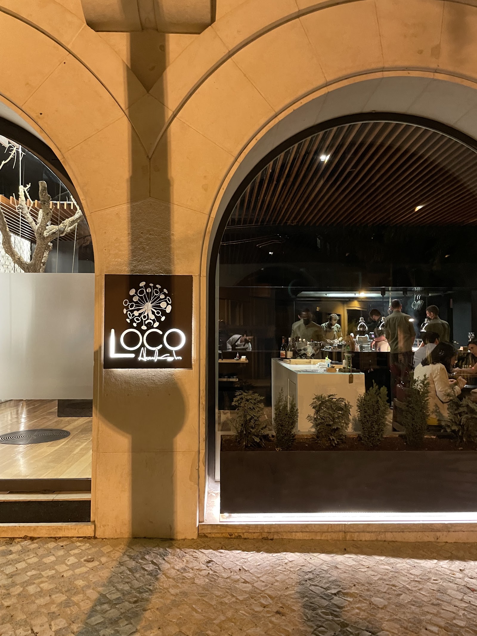 A chef's counter seat set for a solo diner in Lisbon's Estrela