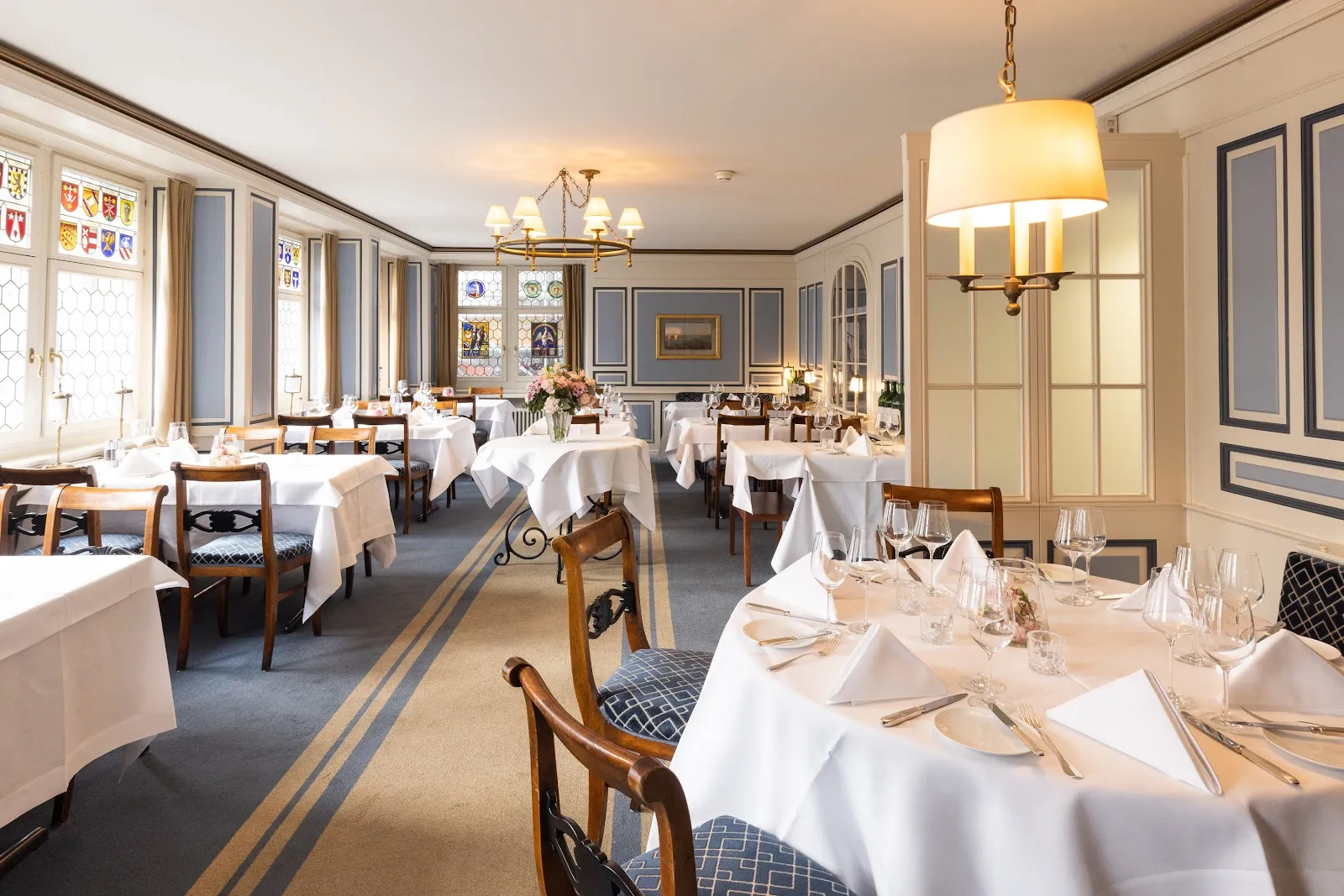 A Zurich guild-hall restaurant set for a large team dinner with long communal tables