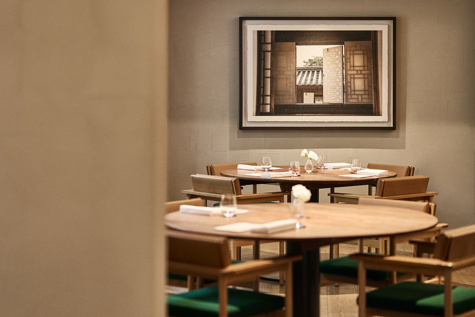 A formal client dinner table set in a Seoul fine-dining room with a city view