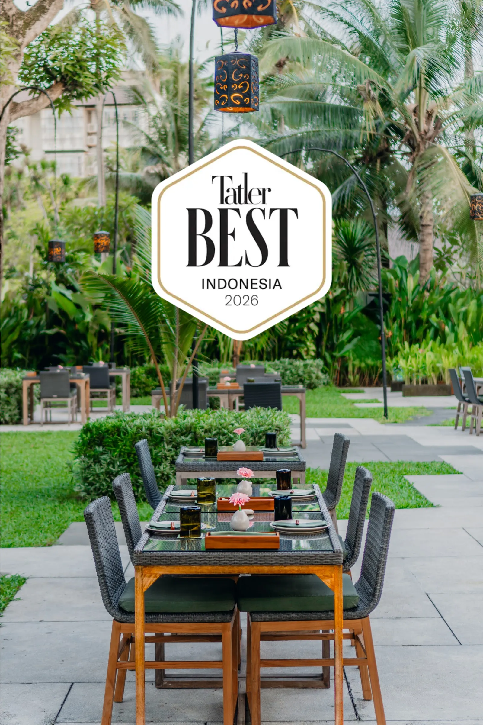 A long garden table set for a team dinner at a restaurant in Seminyak, Bali