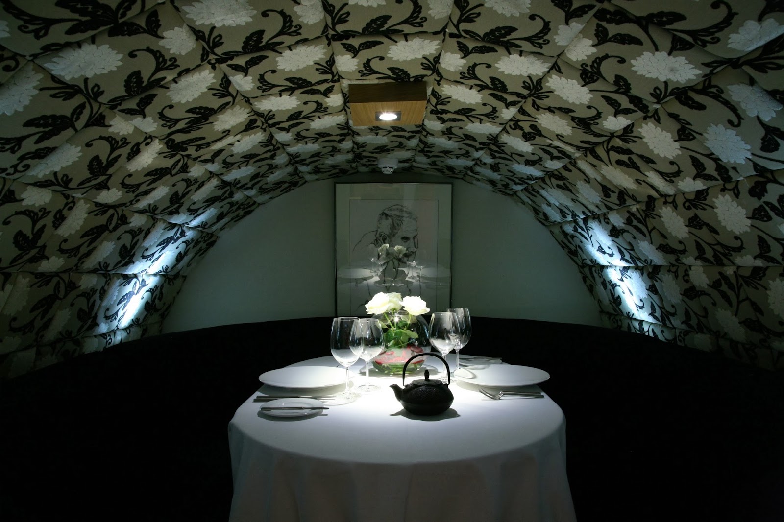 A candlelit two-top set for a first date in a Dublin basement room