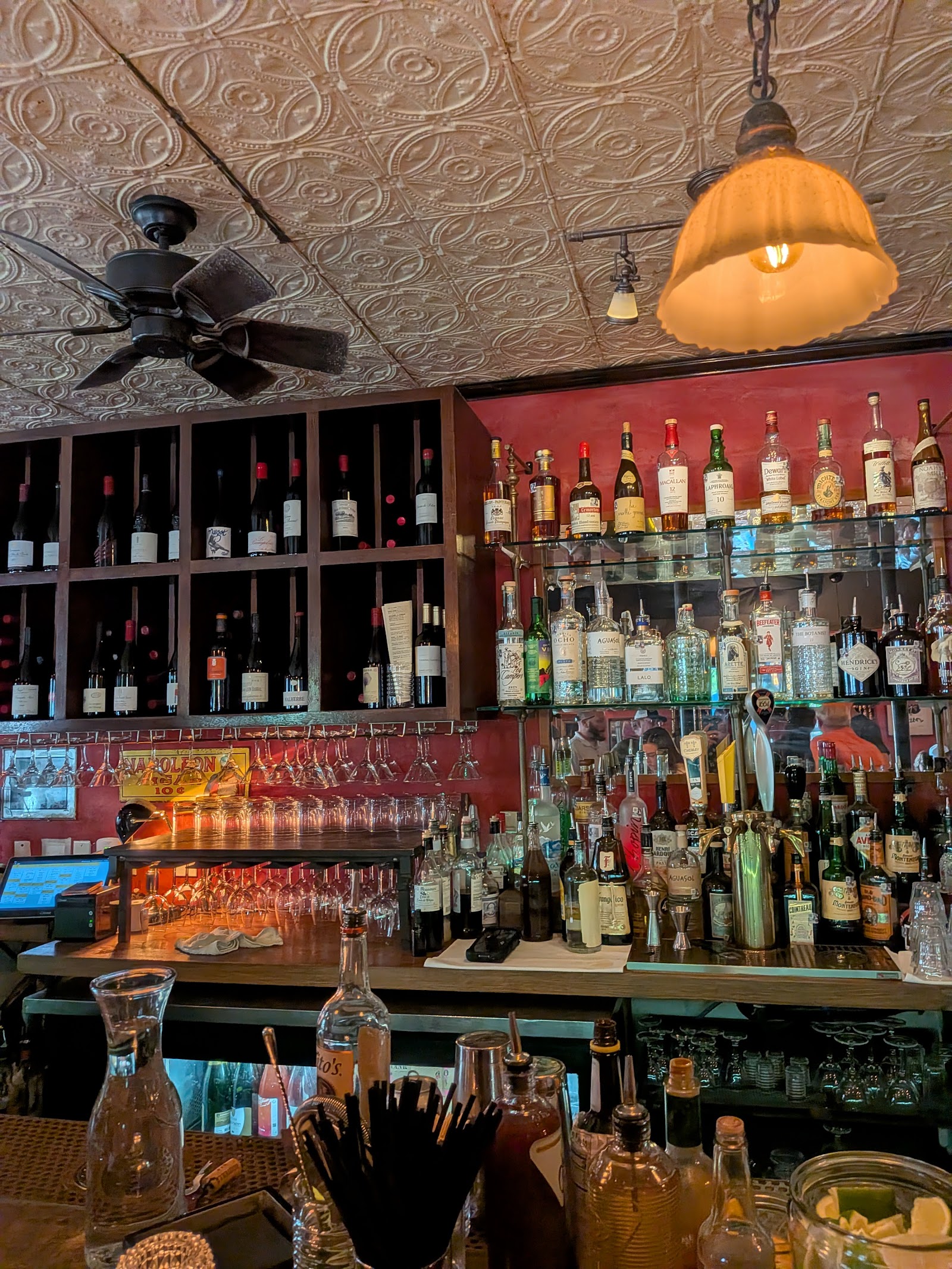 A neon-lit bar and open kitchen serving food late at night in Austin