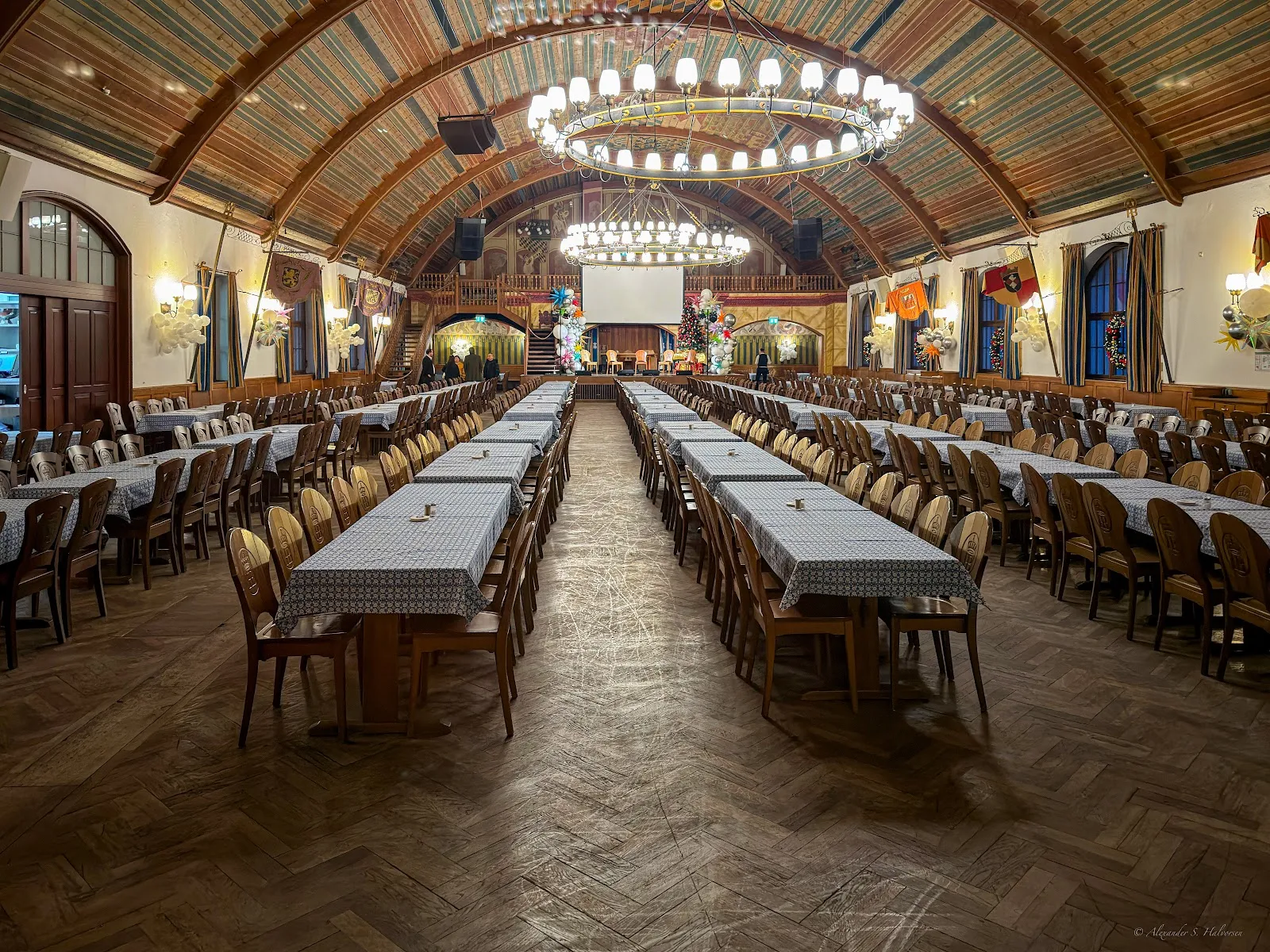 A long communal table set for a team dinner in a Munich beer hall