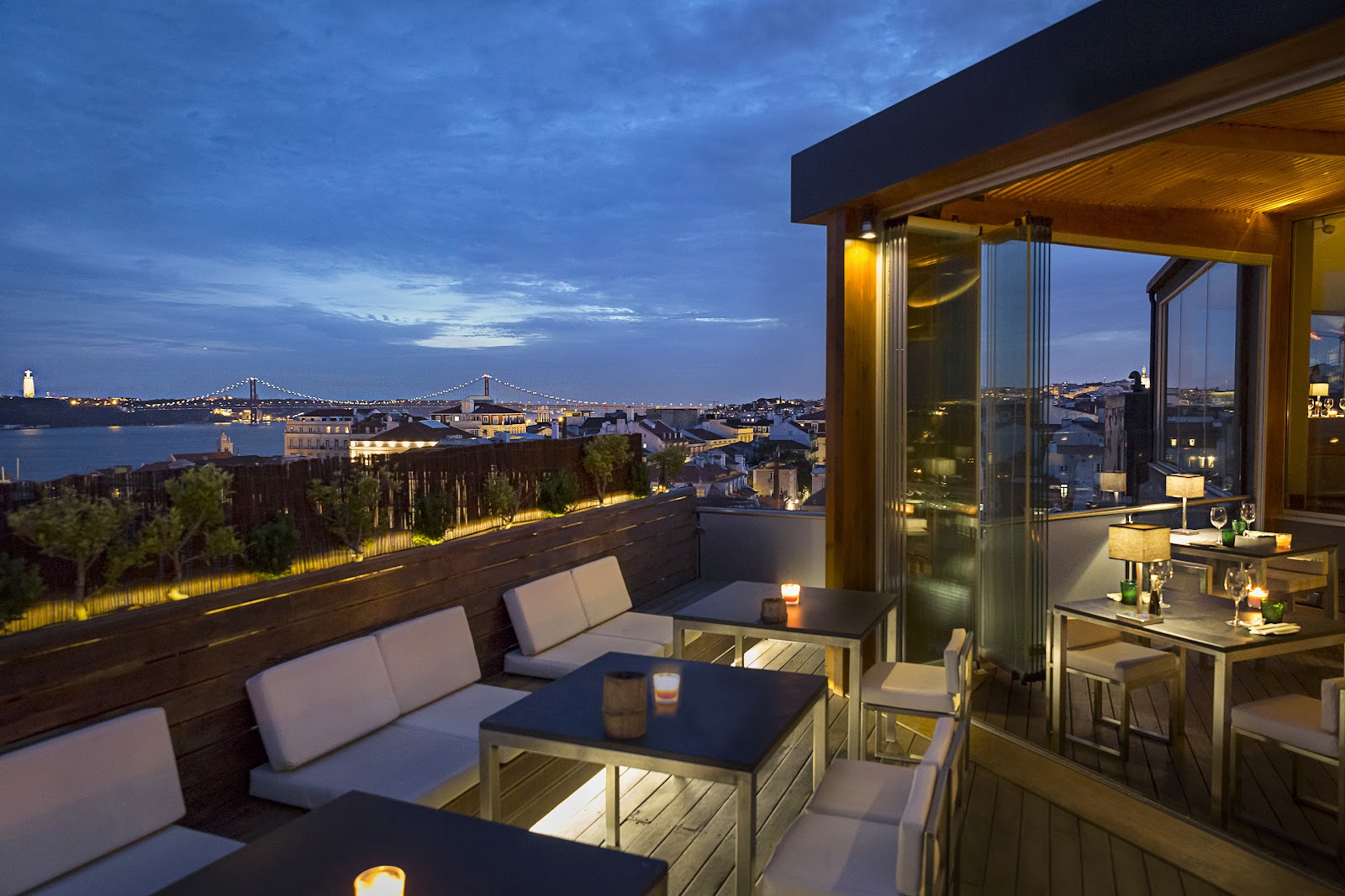 A rooftop dining terrace over Lisbon at dusk