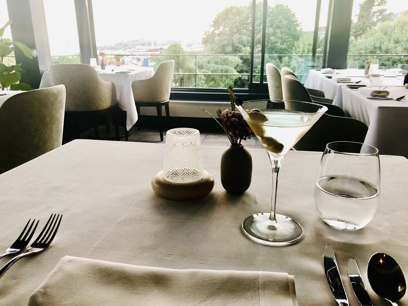 A quiet, well-spaced business dinner table set to close a deal in Istanbul